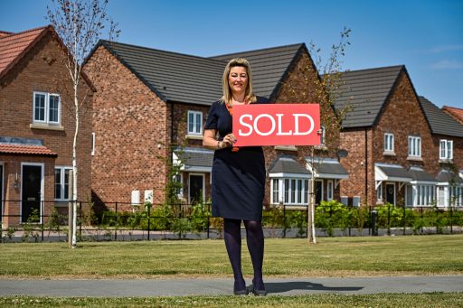 Bellway Amblers Grange sales adviser Paula showcasing the SOLD sign UNPRECENDENTED DEMAND FOR POCKLINGTON HOMES SEES BELLWAY SELL-OUT DEVELOPMENT