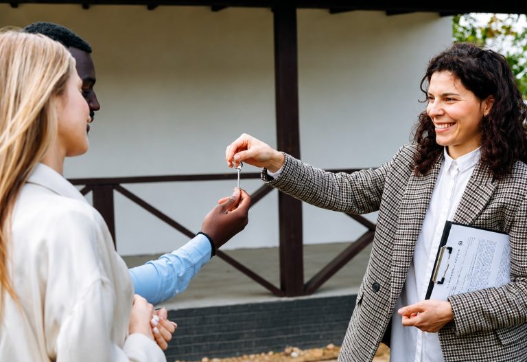 Residential property owner receiving house keys from a property manager