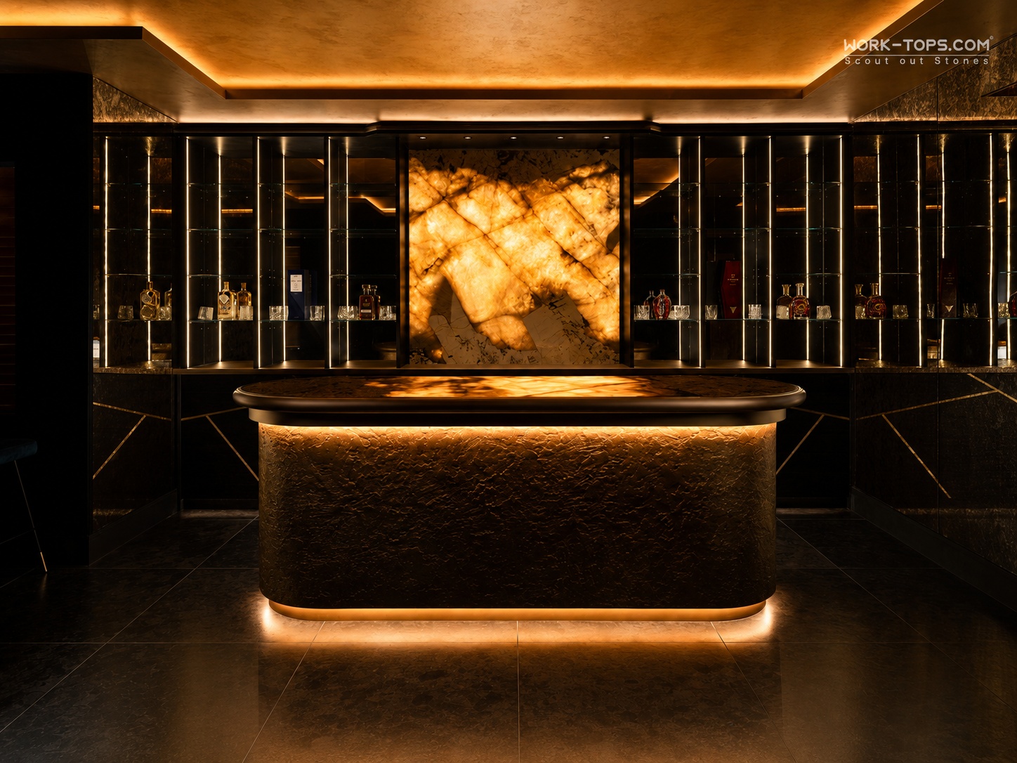 Luxury bar with illuminated quartzite countertop and backlit natural stone feature wall