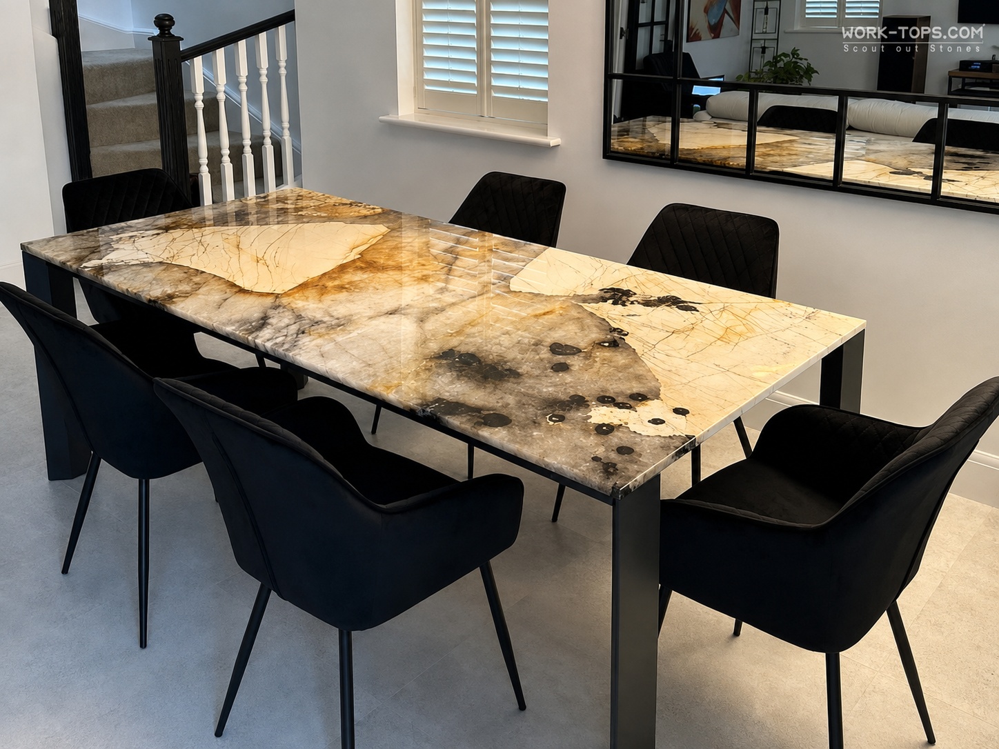 Exotic quartzite dining table with dramatic natural veining in a modern interior