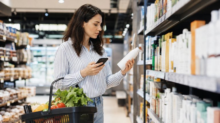 Shopper comparing products and prices while making a value-focused buying decision